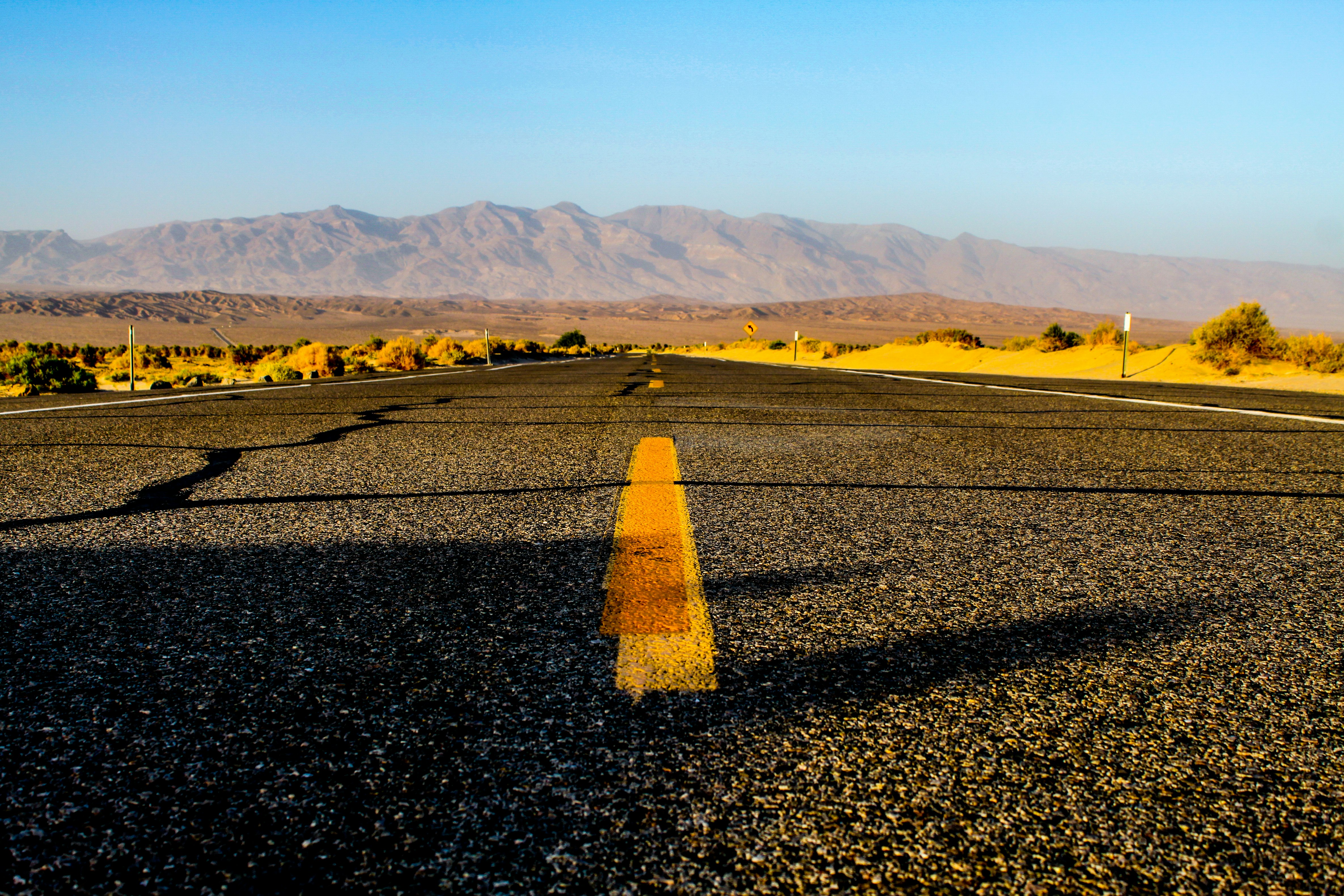 photography of black and yellow concrete road